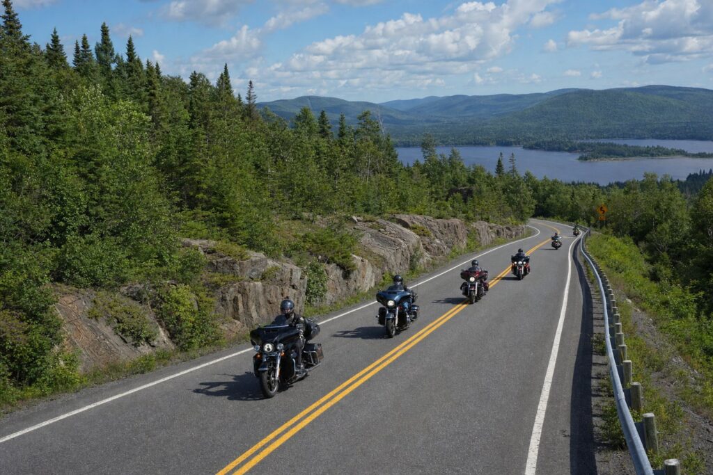Group of motorcyclists on a country road in Québec (replace with a real photo of Phil and the group)